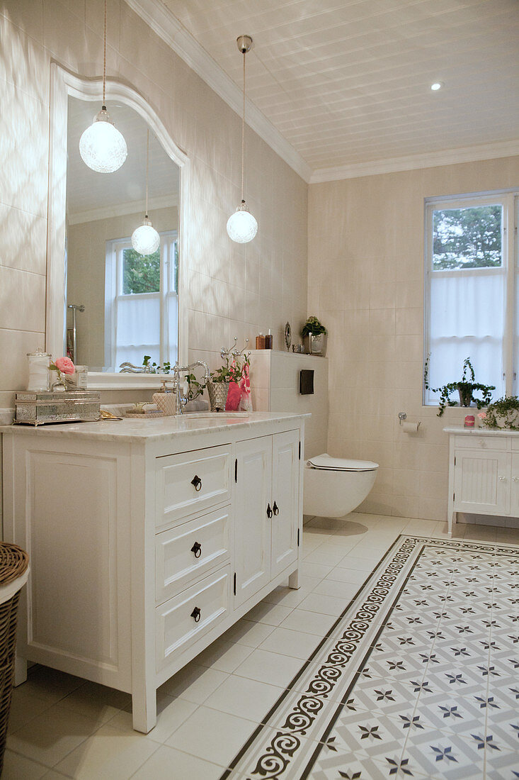 Classic washstand in white bathroom with patterned tiles