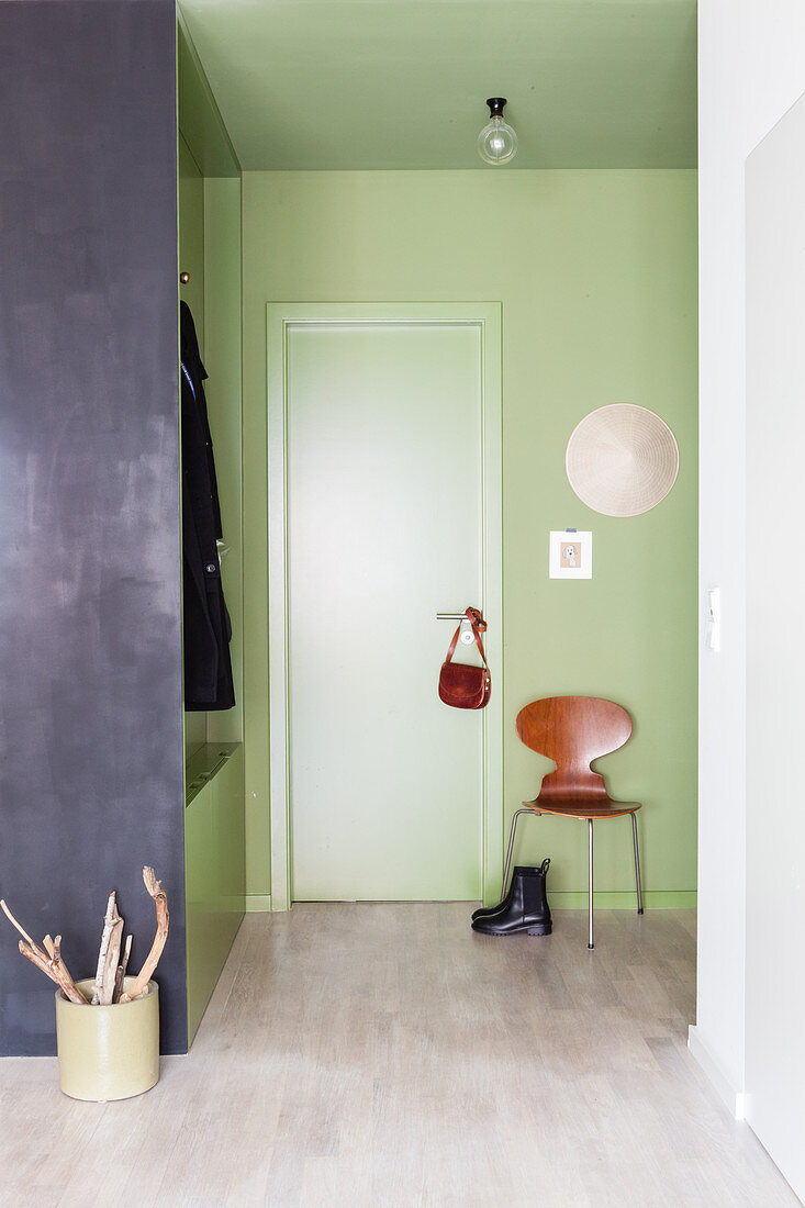 Green foyer with coat rack used as partition