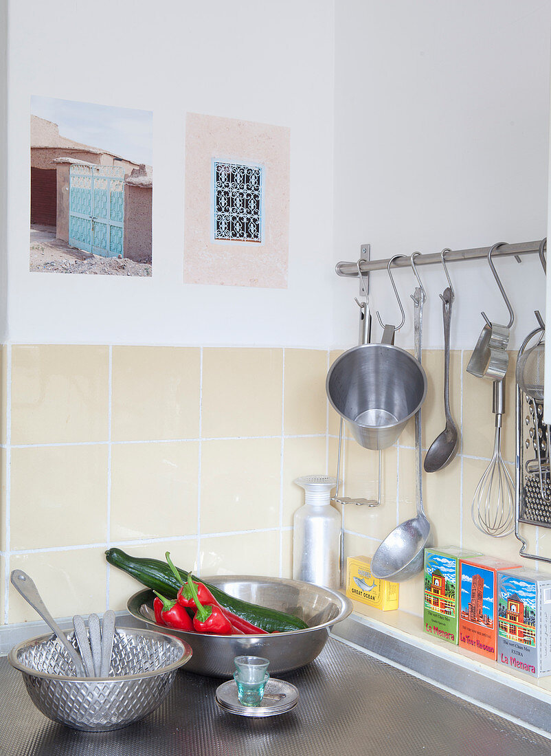 Every day still-life arrangement in kitchen with metal bowls and hooks on rail