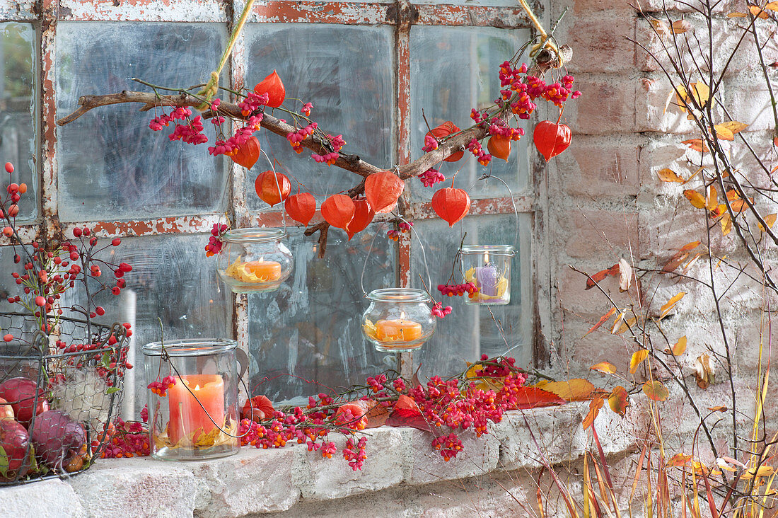 Barn window decorated in autumn, preserving jars as lanterns