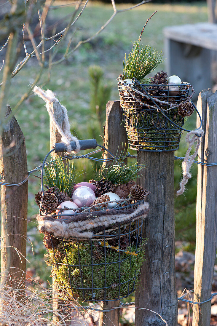 Wire baskets with moss, cones, pinus and silver baubles
