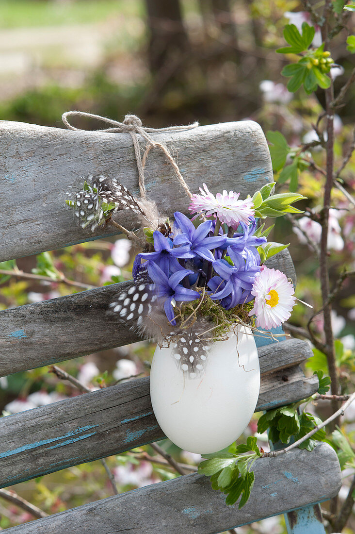 Small Easter bouquet in duck egg hung as a vase on chair back