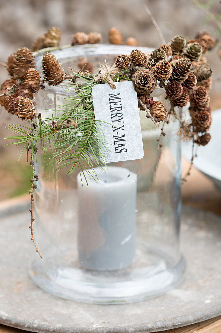 DIY candle lantern decorated with larch cones