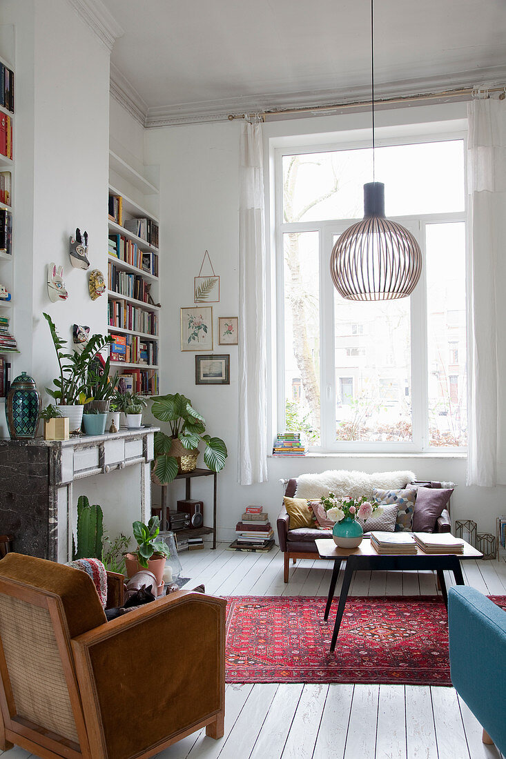 Large windows and mantelpiece in vintage-style living room