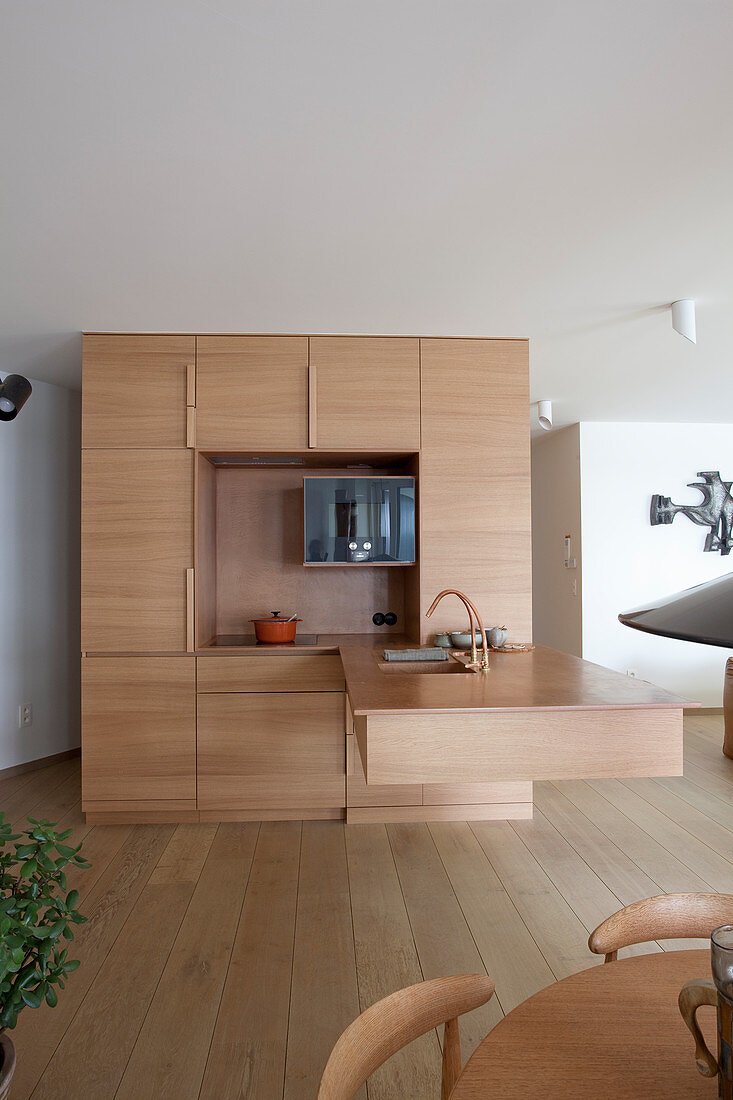Cubic designer kitchen with floating counter in open-plan interior