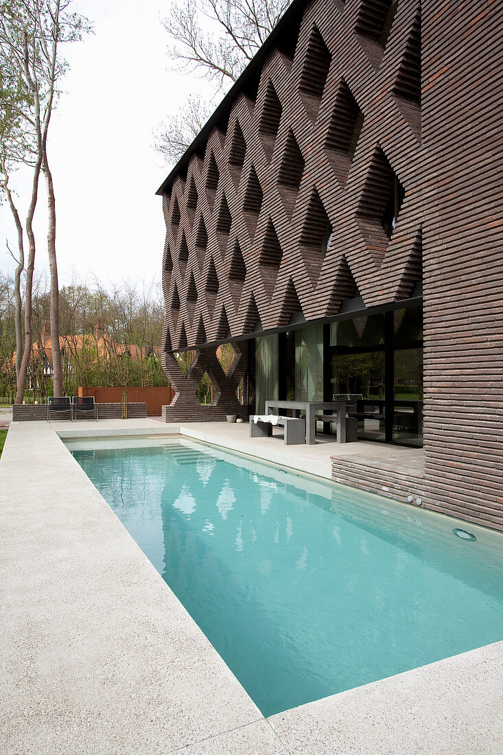 Terrace and swimming pool outside modern architect-designed house