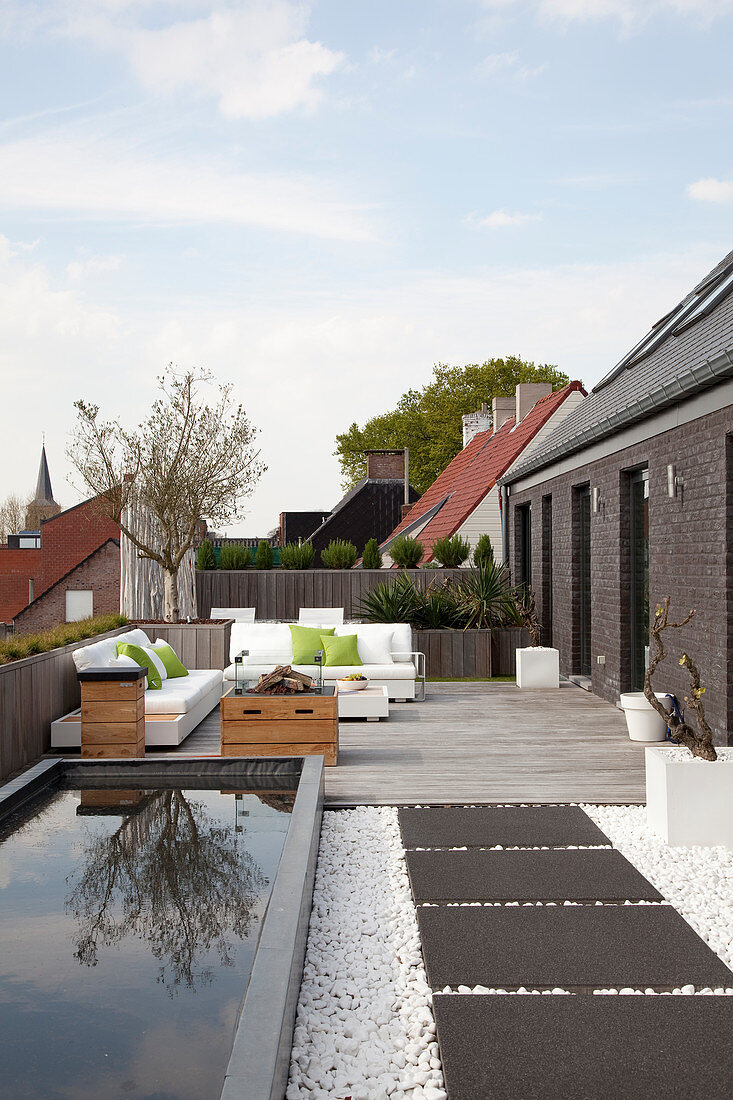 Rectangular pond and seating area on large modern roof terrace
