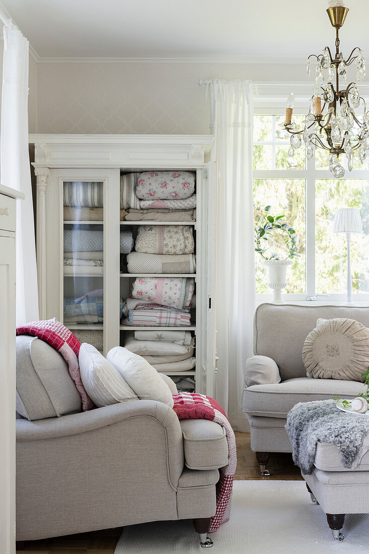 Blankets in lovely old glass-fronted cabinet in living room