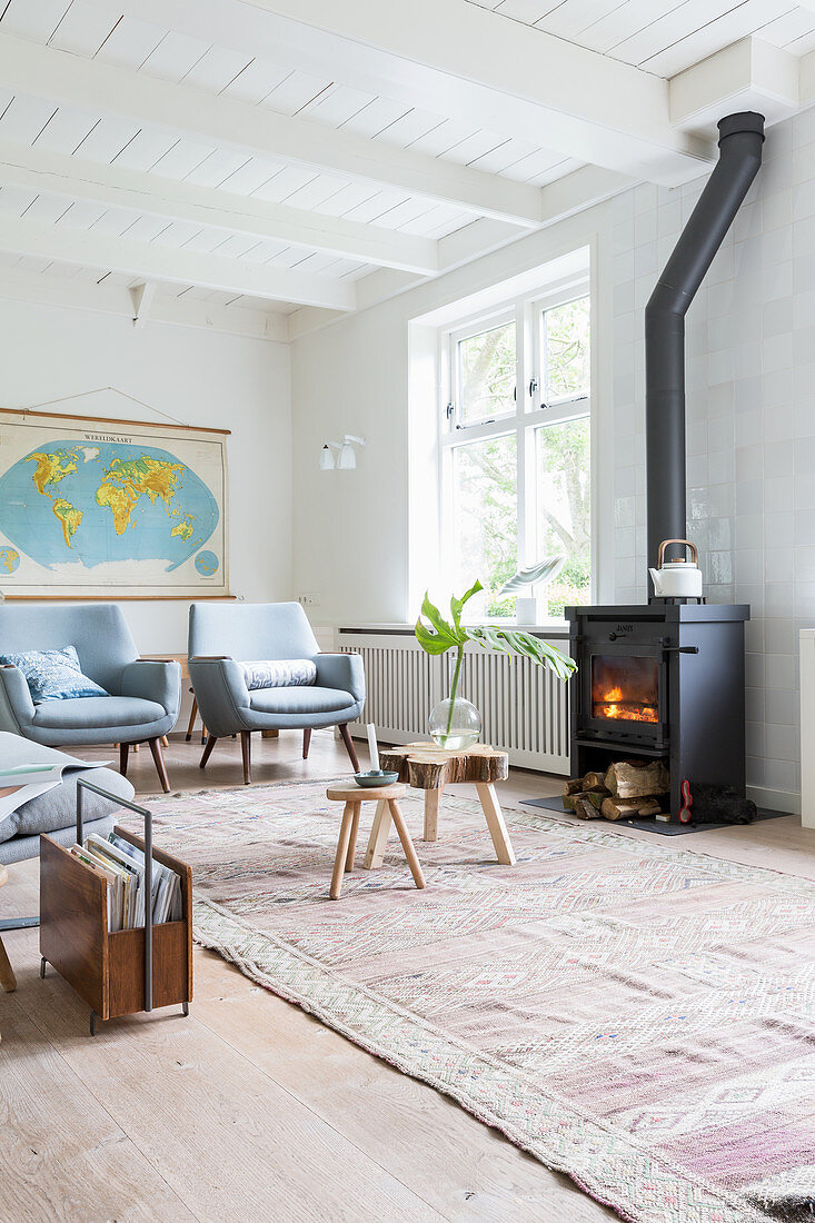 Log burner in bright, Scandinavian-style living room