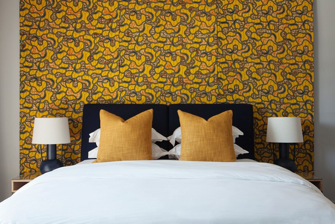 Bedroom with black, white and yellow colour scheme and wallpaper with graphic pattern