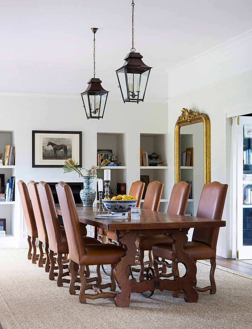 Brown upholstered chairs around the wooden table in the dining room