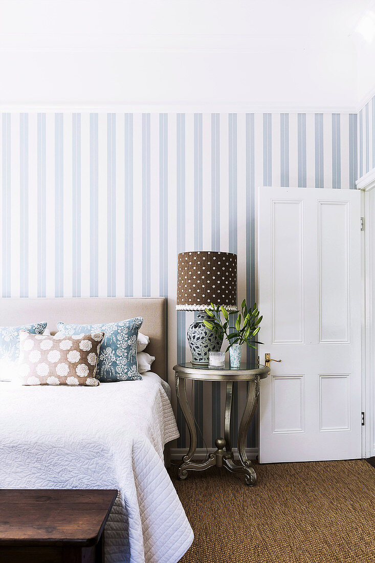 Blue and white striped wallpaper in the bedroom