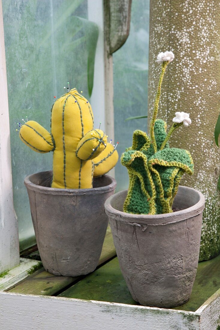Hand-sewn cactus and crocheted succulent in grey plant pots