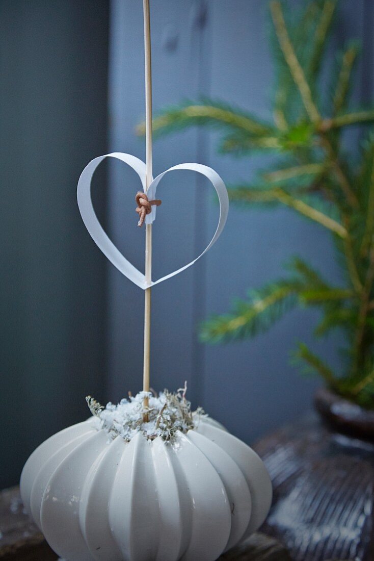 Paper heart on stick in vase with structured surface