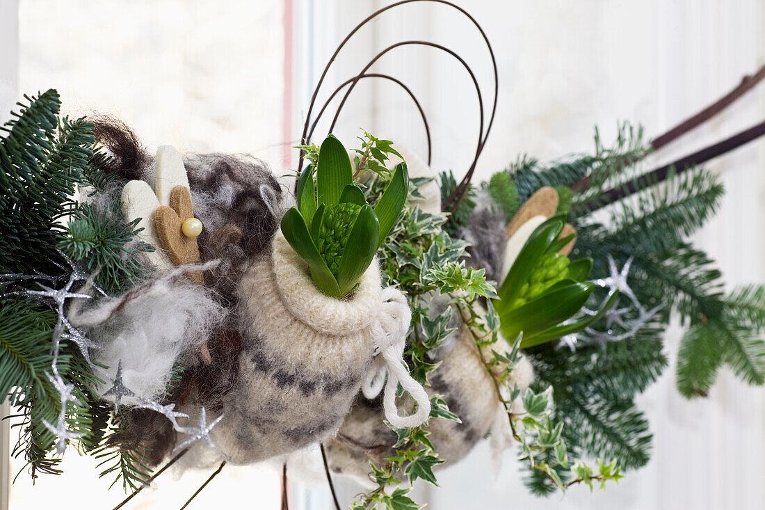Hyacinths wrapped in a knit wool sleeve on a DIY Christmas garland