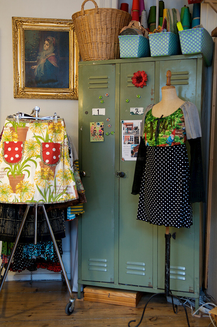 Clothes rack and dress form with self-sewn clothes in front of the locker