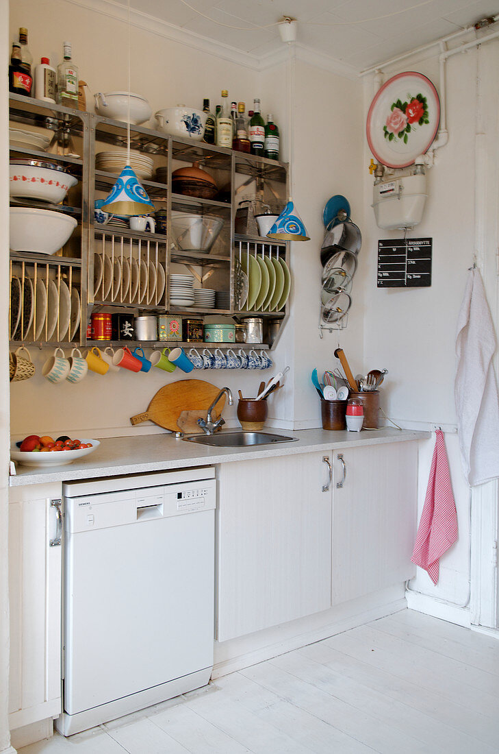 Shelf with dishes in a simple kitchen with a white floor