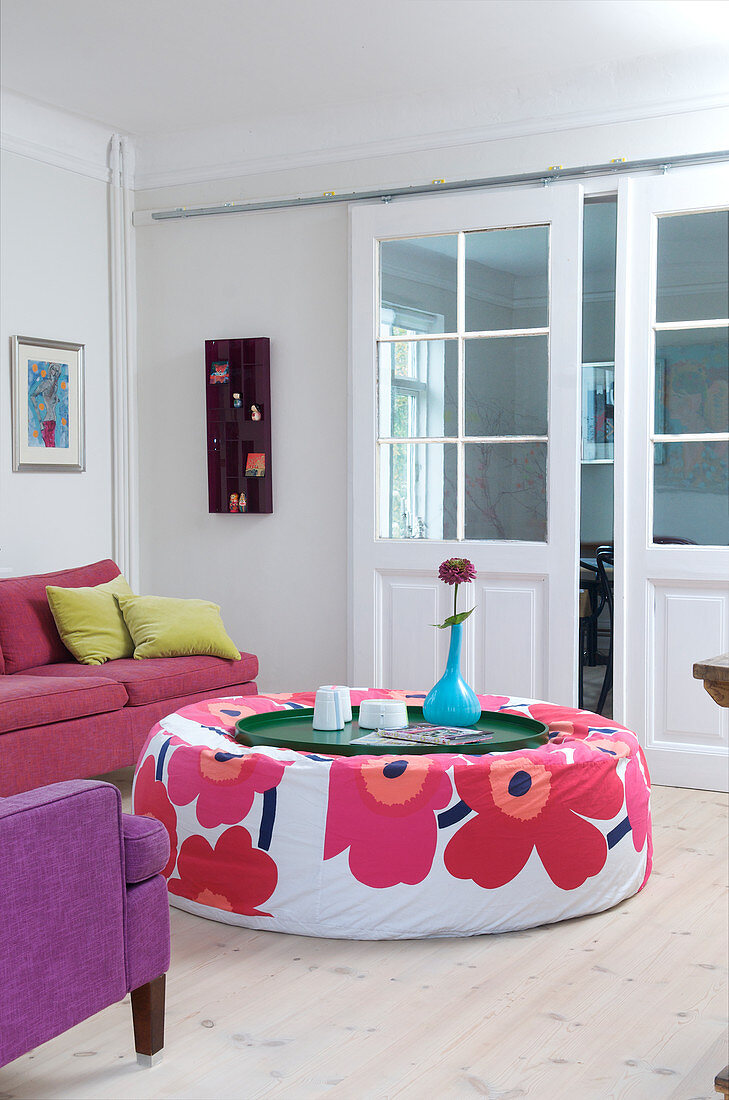 Ottoman with floral motif in colourful living room