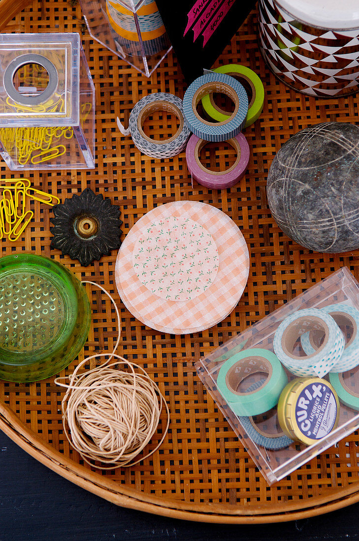 Masking tape and craft materials in a wicker tray