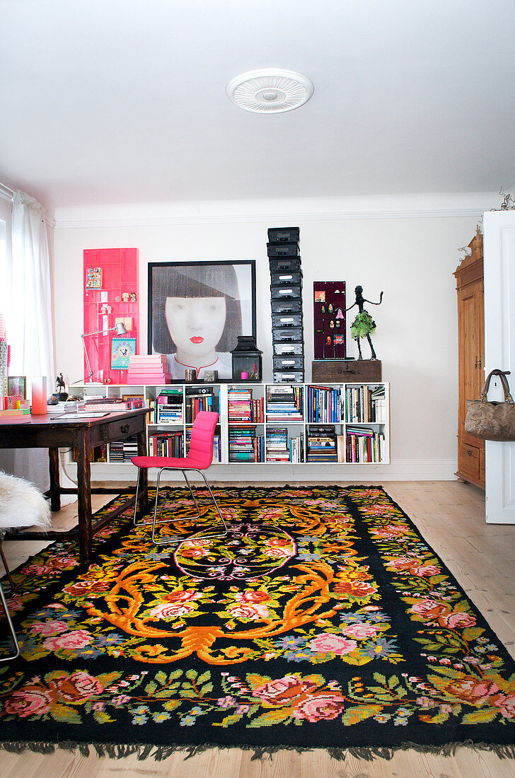 Ethnic rug in study with floating shelves