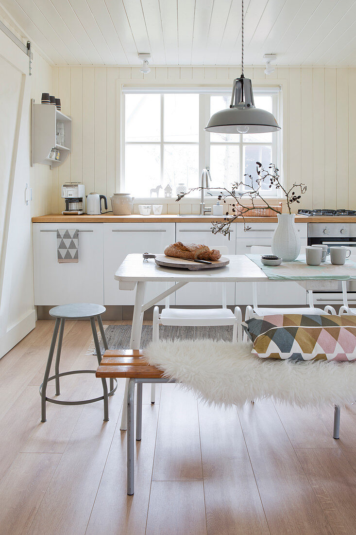 Bright eat-in kitchen in Scandinavian country house style in winter