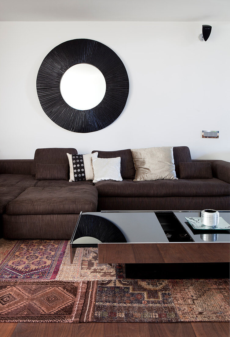 Coffee table with storage compartment in front of sofa in living room in shades of brown