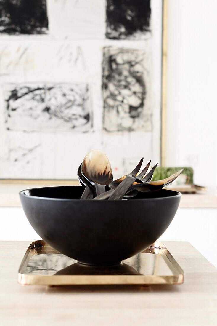 Salad bowl with utensils on a kitchen table