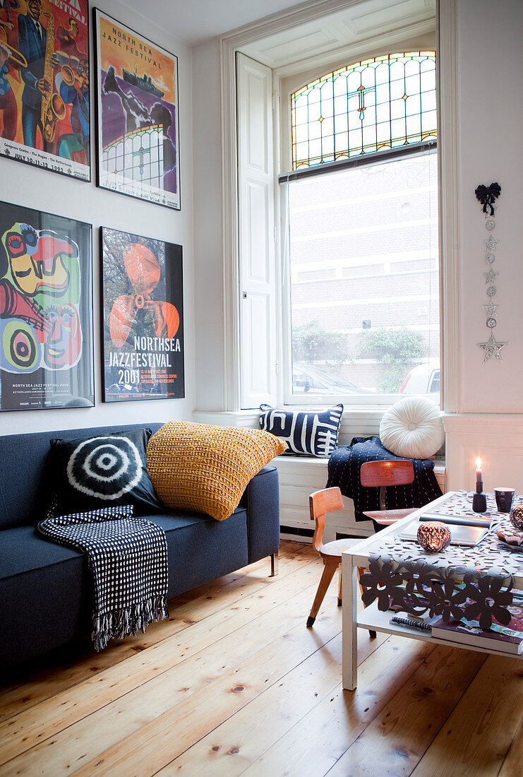 Framed posters above the sofa in a wintry living room