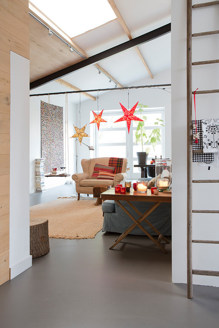 Stars hung from beam in festively decorated living room