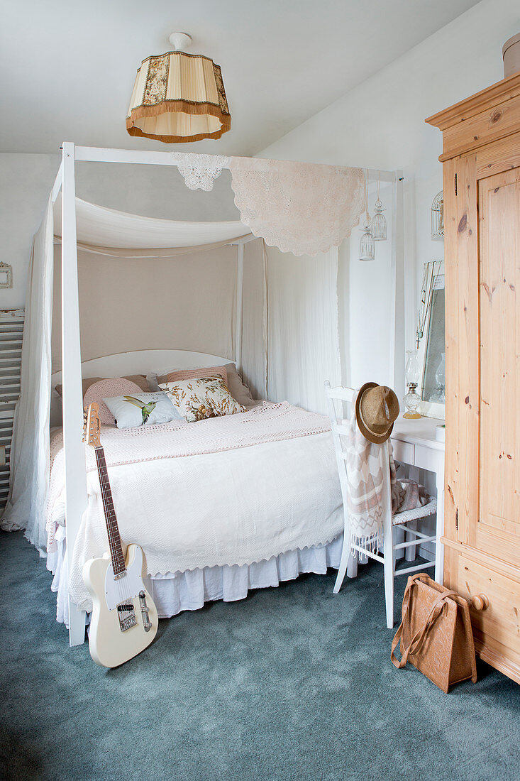 Four-poster bed in vintage-style bedroom