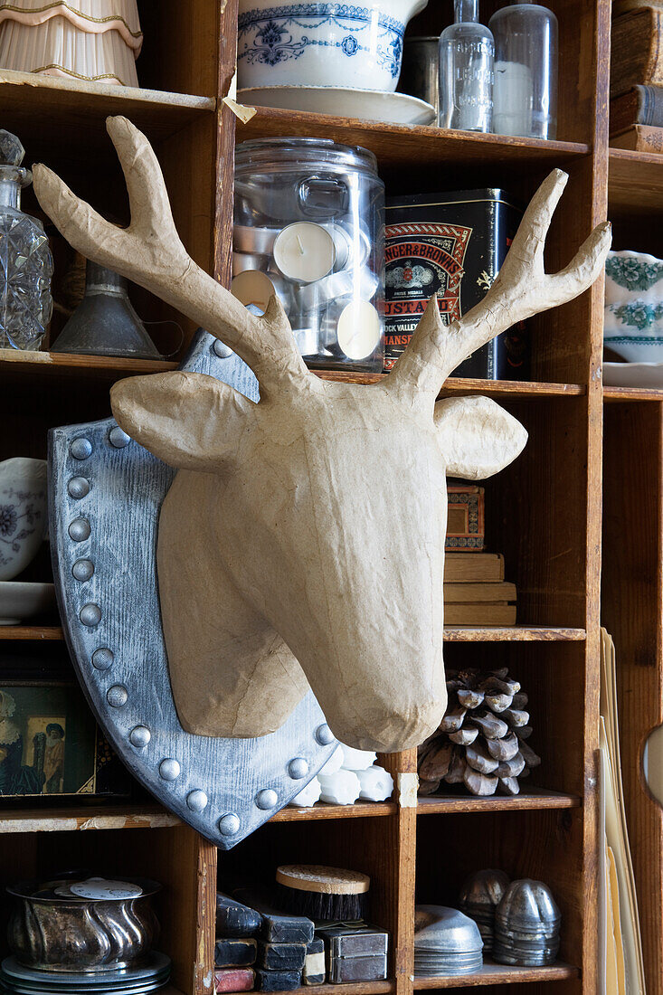 Cardboard deer head mounted on trophy plate as a Christmas decoration