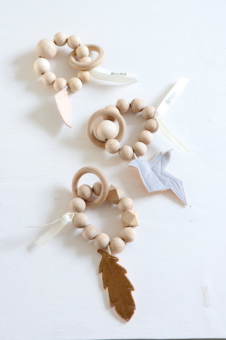 Baby toys made of wooden beads with a wooden ring and felt tag