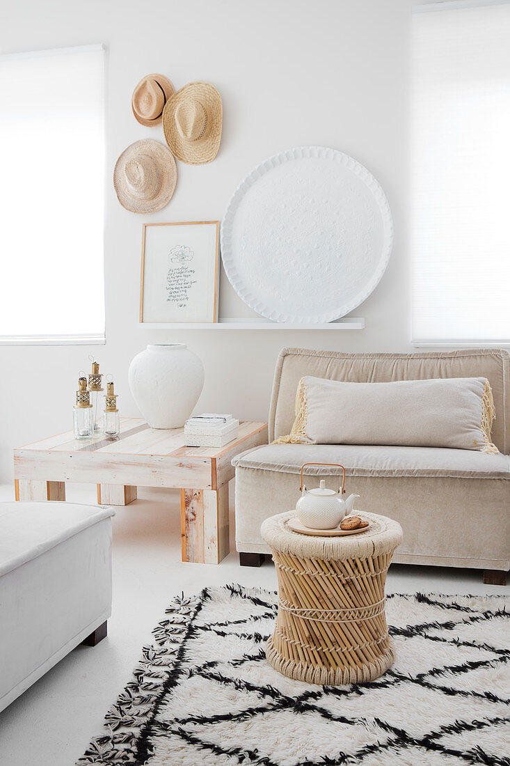 A side table on a diamond patterned rug in a light living room