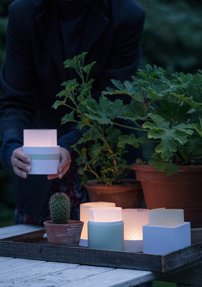 Homemade lanterns made of tracing paper on a tray