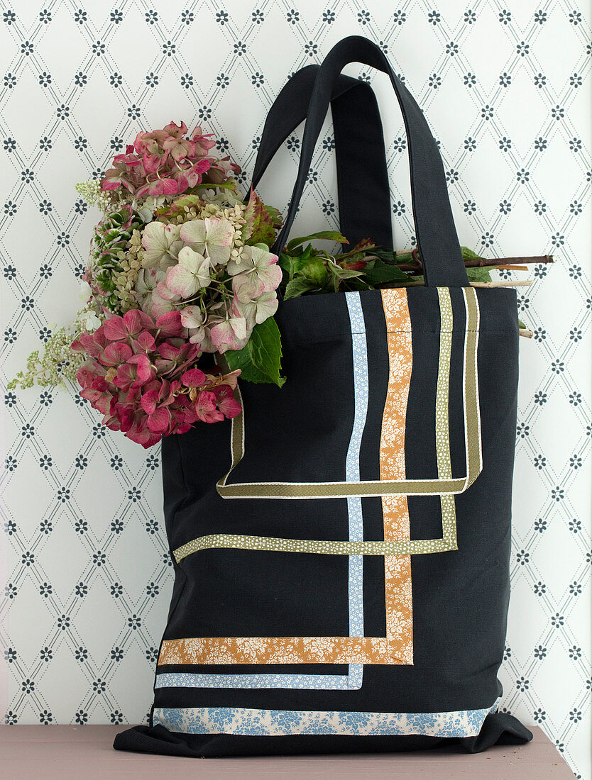 Aufgenähte Stoffbänder auf einer Einkaufstasche mit verschiedenen Hortensien