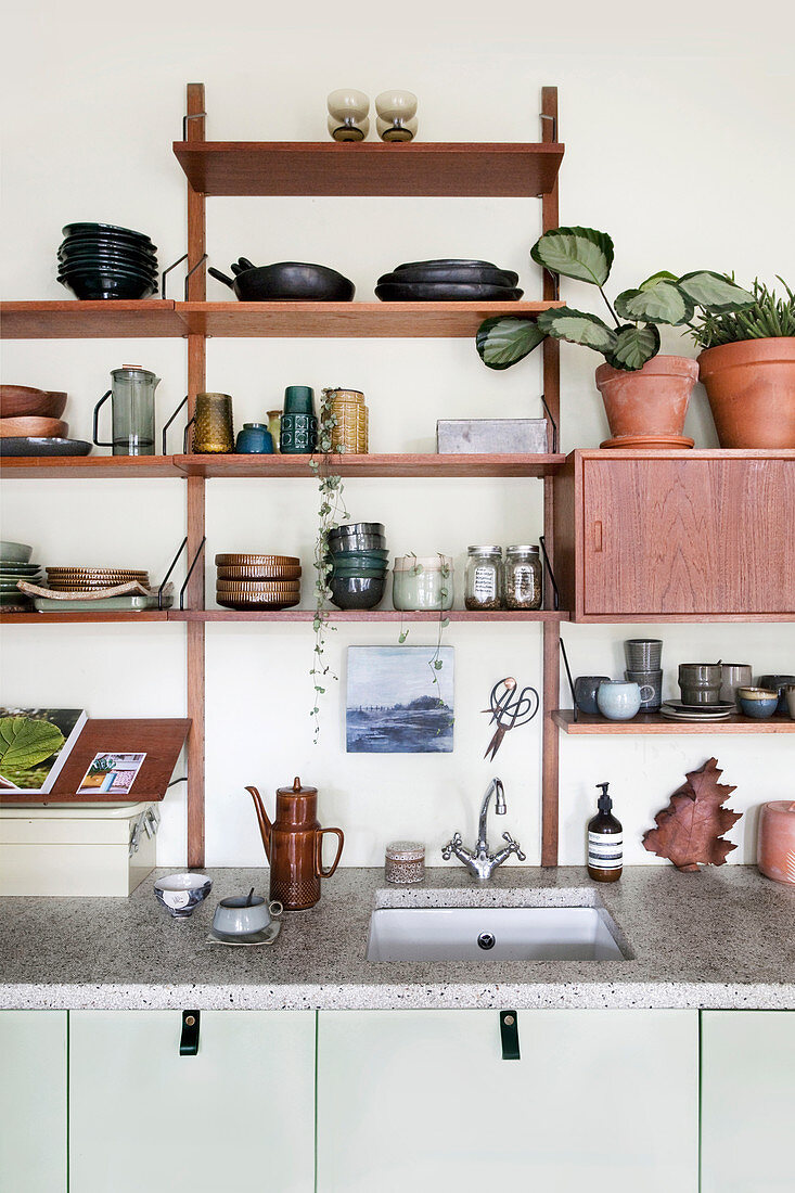 Wall shelf with dishes above the kitchenette