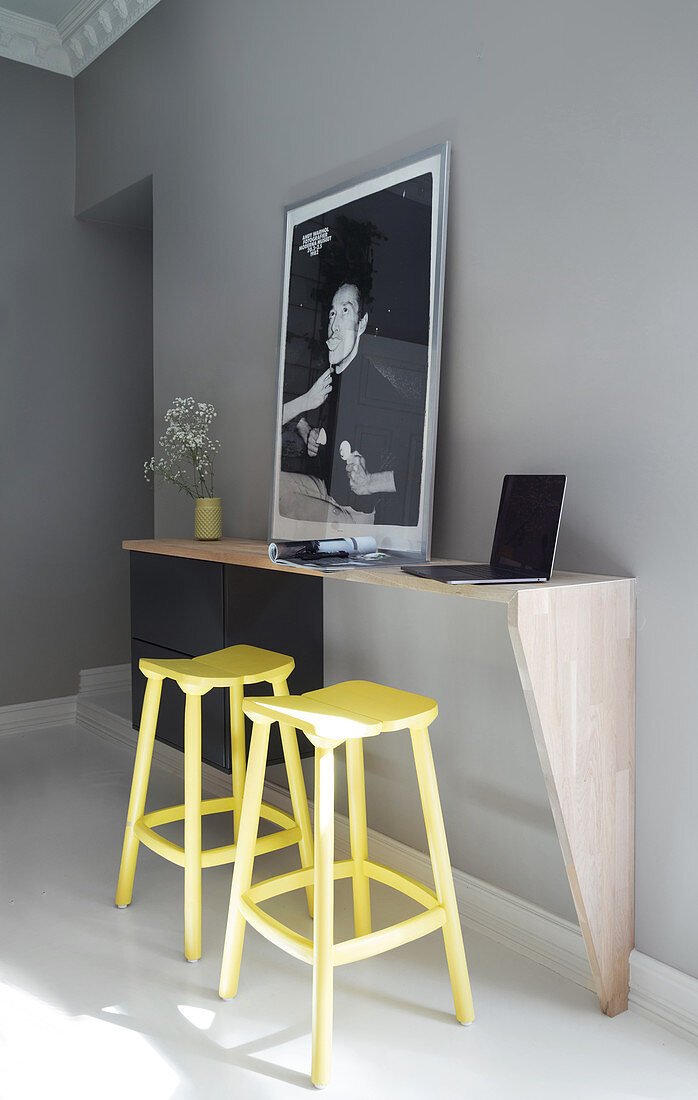 A breakfast bar with yellow bar stools