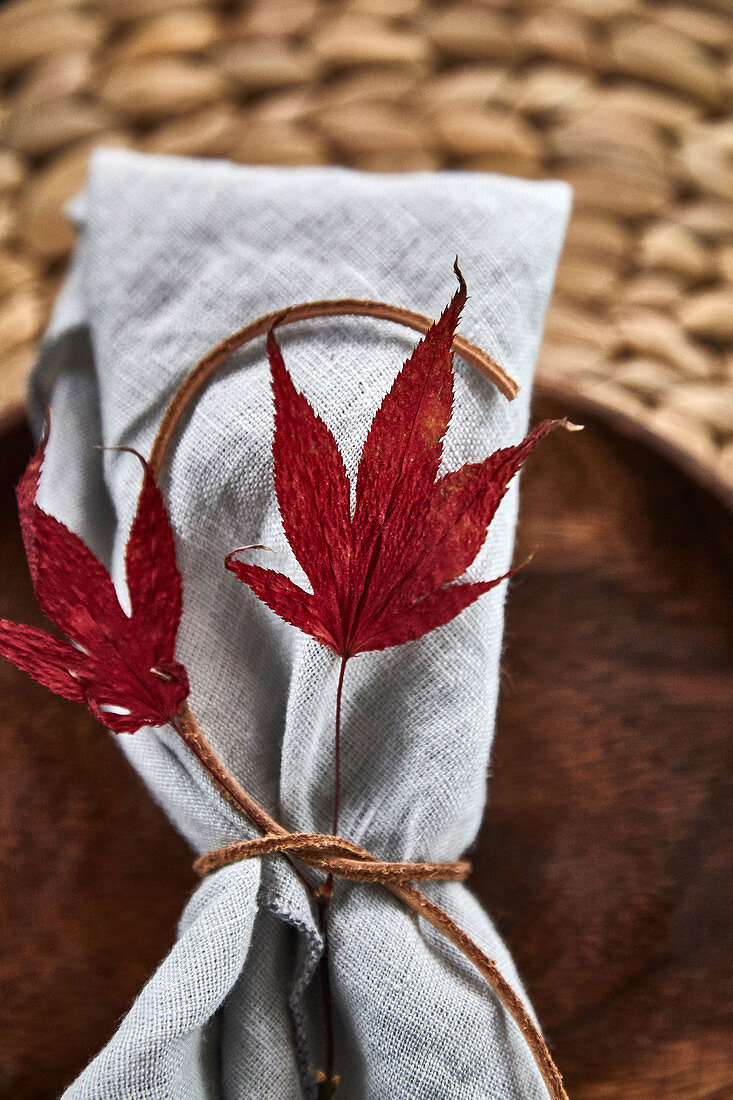 A place setting decorated with autumn leaves