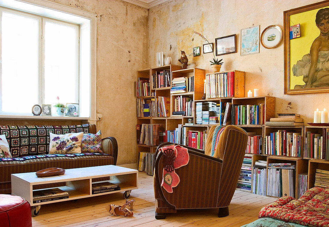 A bookcase made of wooden boxes in a vintage-style living room