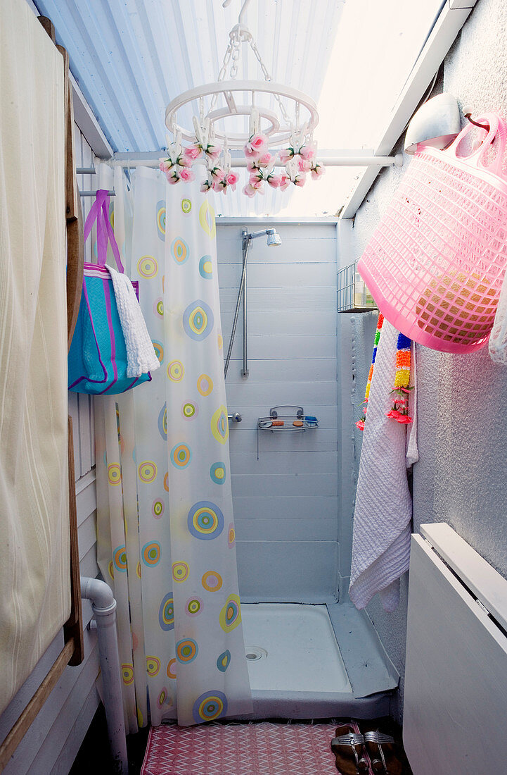 Small improvised shower as an extension with kitschy decoration