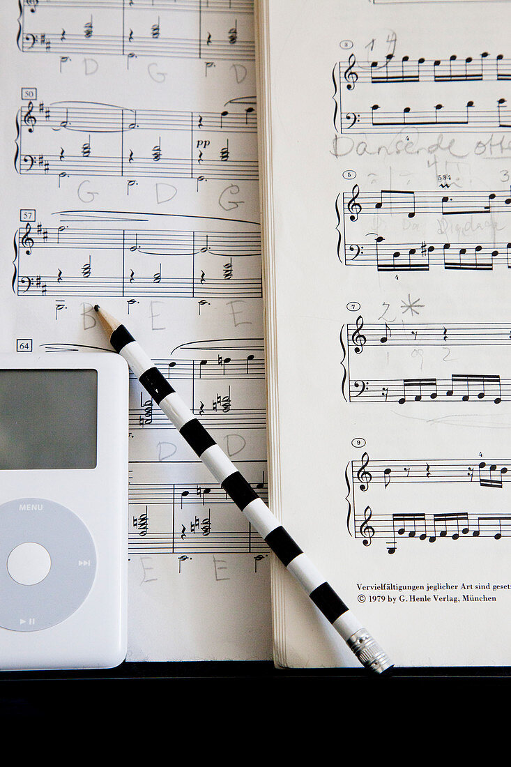 Black and white striped pencil in front of sheet music
