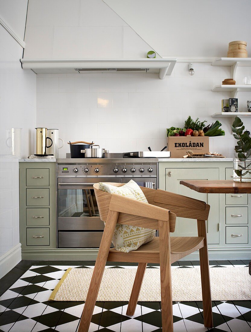 Classic eat-in kitchen with painted floorboard with a checkerboard pattern