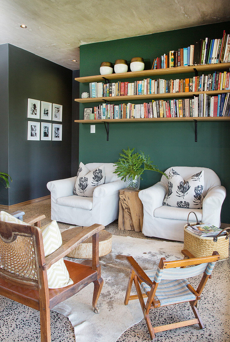 Living room in natural shades with dark green wall