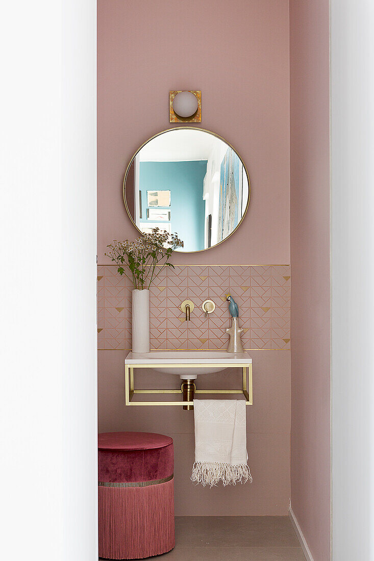 Elegant, feminine pink bathroom with gilt details