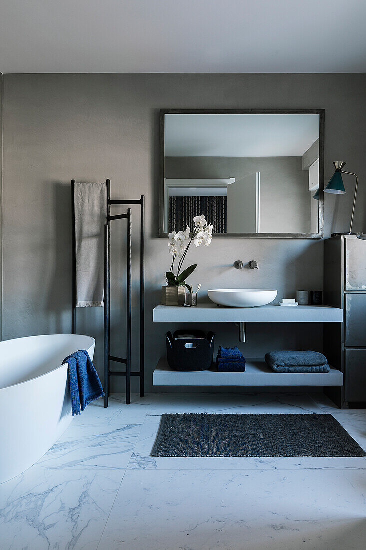 Bathroom in shades of grey with marble floor and modern washstand