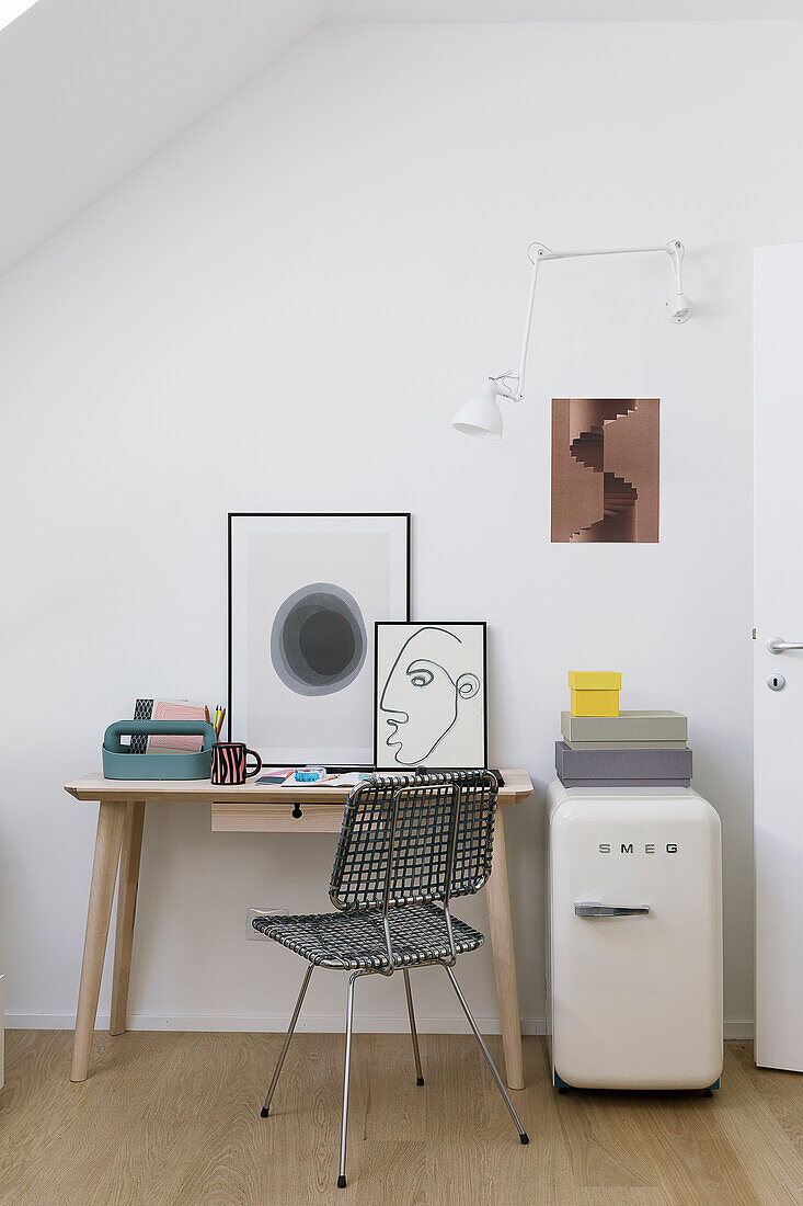 Metal chair at desk, pictures and small retro fridge