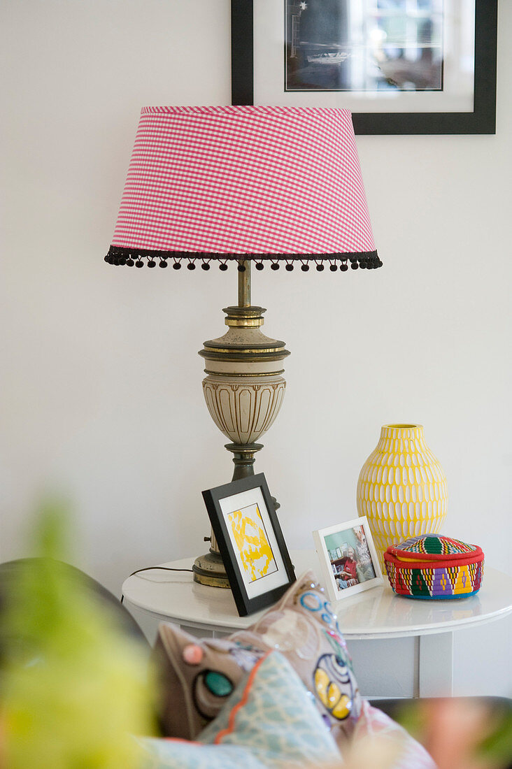 Table lamp with red-and-white gingham lampshade and pom-pom trim