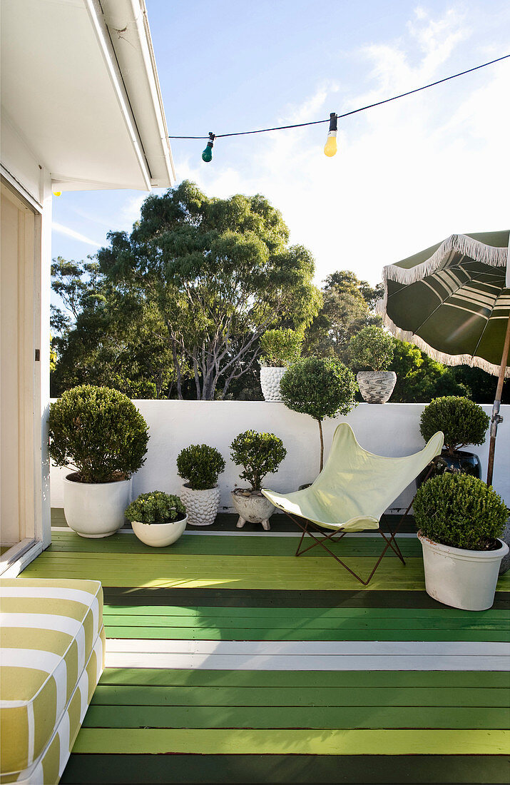 Roof terrace with board floor painted in various shades of green