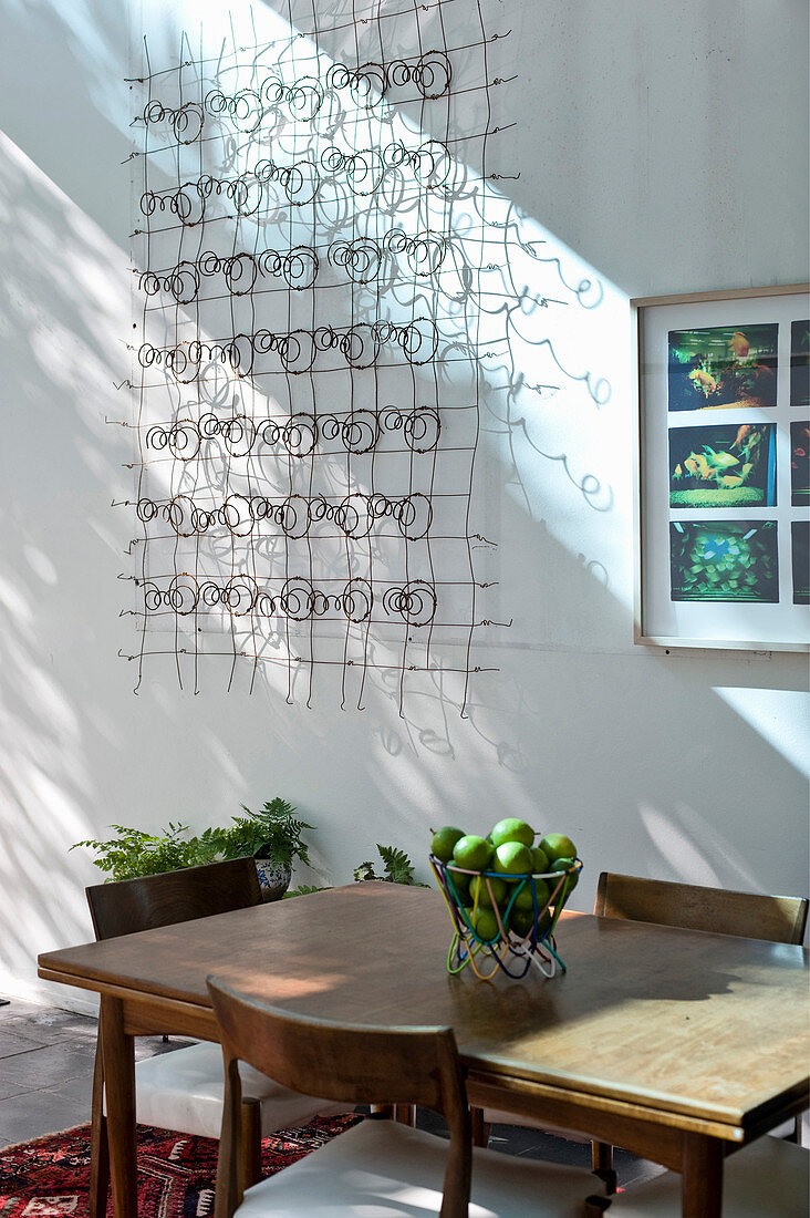Wooden table and chairs and wall decoration made from wire springs