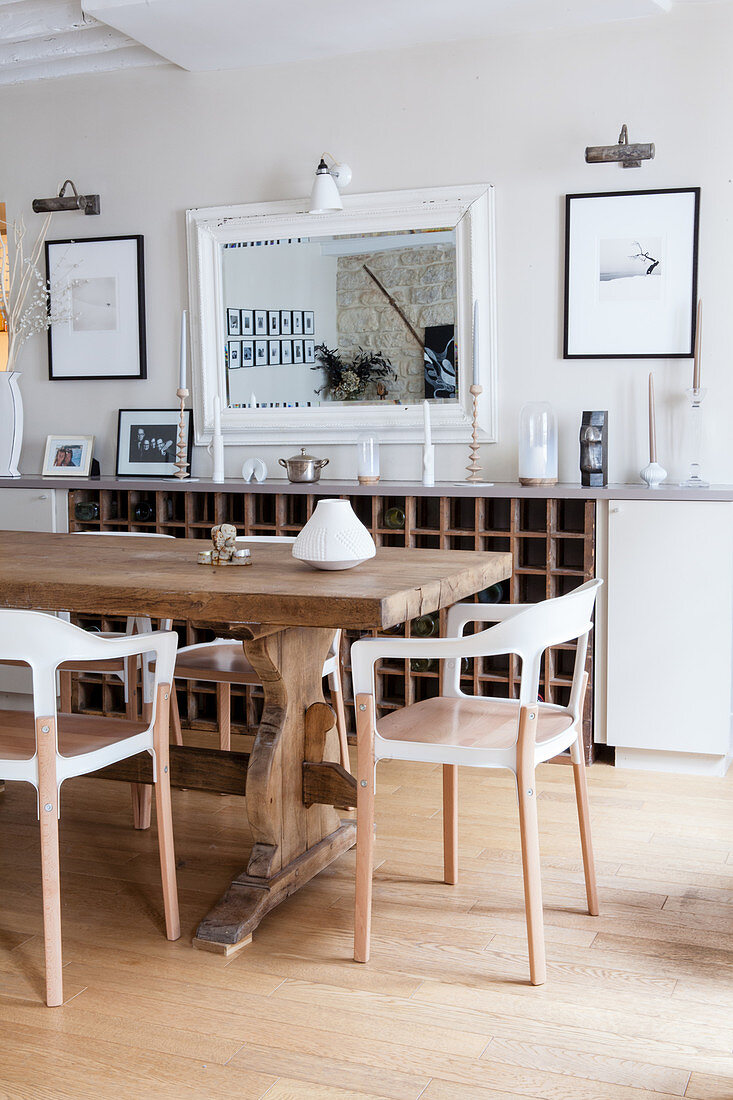 Modern chairs around rustic wooden table in dining room